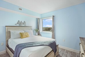 Unwind in this serene bedroom featuring a cozy queen bed, coastal décor, and a bright window with peaceful views. The perfect Myrtle Beach retreat for rest and relaxation after a day of sun, sand, and adventure!