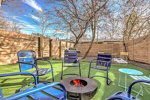 Backyard with outdoor seating, fire pit, and hot tub 