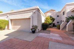 Two car garage across from pool.