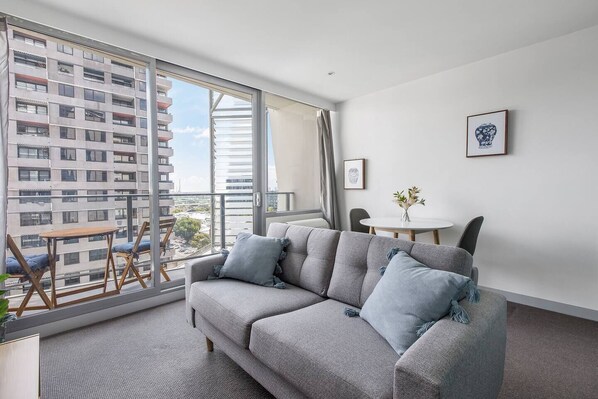 Lounge comfortably in the living area, perfect for kicking back with your favourite TV shows on the two-seater sofa.