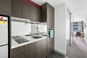 Whip up simple meals in the compact kitchen equipped with all the essentials, including an oven and French press.