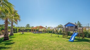 Spacious green lawns with a playground and shaded seating make this outdoor space perfect for kids and relaxing afternoons. #FamilyFun #GardenGetaway