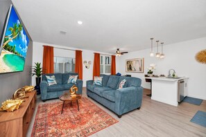 Spacious and inviting living room with plush seating and a smart TV for cozy movie nights.