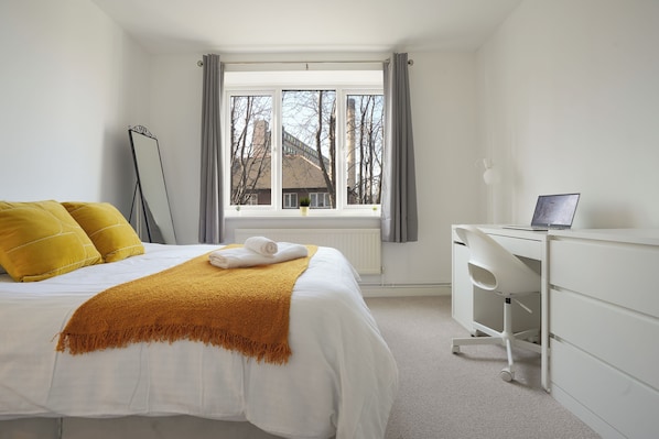 Main bedroom with work space and a 3 door wardrobe 