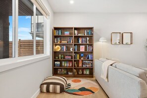 Two bookshelves full of kids, teen and adult book & board games.
