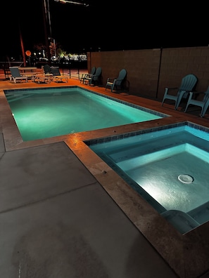 The pool and hot tub after dark.