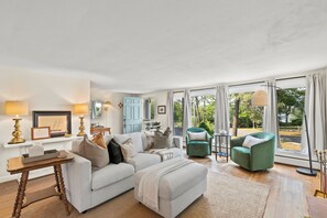 Cozy living room with staunning pond views + fireplace – relax and unwind!