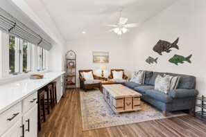 The Family Living Area is the heart of the home, complete with a 65" TV and a convenient cooler for refreshments.