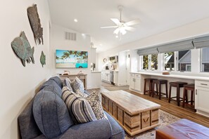The Family Living Area is the heart of the home, complete with a 65" TV and a convenient cooler for refreshments.