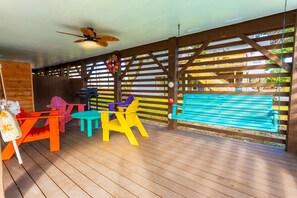 Step outside to enjoy an under-house Outdoor Dining Area complete with a Gas Grill—perfect for barbecues after a day at the beach.