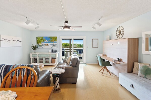 The open-concept design boasts bamboo flooring and a Kitchen with a breakfast bar where you can enjoy delicious meals together indoors.
