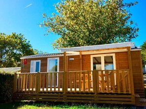 Charming wooden terrace of the cottage, ideal for enjoying the serene natural surroundings.
