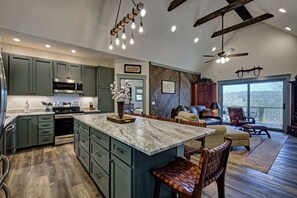 Kitchen, bar and living room, doorway to master bedroom