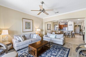 Spacious open-concept living, dining, and kitchen area with beautiful lake views, perfect for relaxing and entertaining.