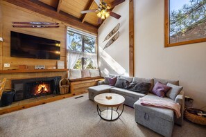 Great living room space w/ cozy seating area, flatsceen TV, and woodstove.