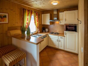 Furniture, Interior Design, Flooring, Wood, Kitchen, Floor, Cabinetry, Countertop, Room, Kitchen Appliance