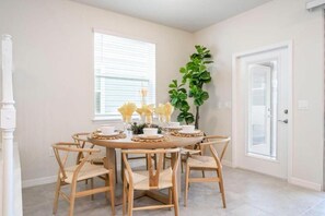 Bright dining area with natural light, stylish seating, and a welcoming vibe.