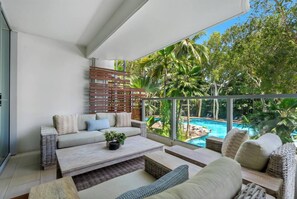 Sip a glass of wine on the balcony lounge, shared by the primary suite and living area, while overlooking the serene lagoon pool.