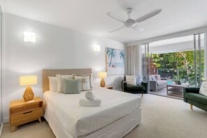 Drift into a restful sleep in the serene primary suite, complete with a queen-size bed and direct balcony access.