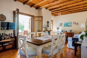 The delightful open plan living and dining area with French windows