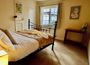 Peaceful Bedroom – Comfy double bed, soft linens, and a bright, airy space.
