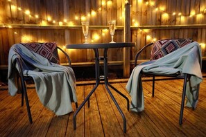 A Cosy Outdoor Retreat - Relax under fairy lights with a drink and unwind.
