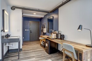 Sleek workspace with warm wood tones and industrial accents, ideal for unwinding or catching up on tasks.