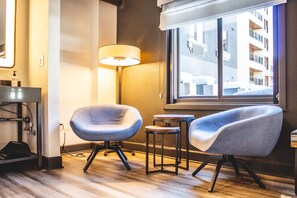 Cozy seating nook bathed in natural light, perfect for enjoying a morning coffee or a quiet moment of relaxation.