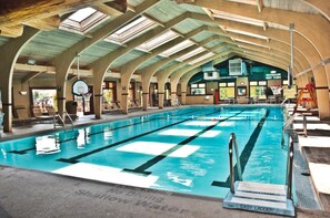 Bright indoor pool with soaring ceilings and abundant natural light, perfect for a relaxing swim in any season.
