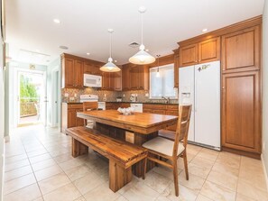 Spacious kitchen with a wooden table seating eight.
