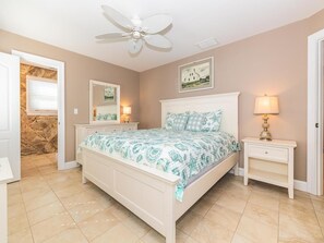 Spacious master bedroom with natural light and cozy bedding.