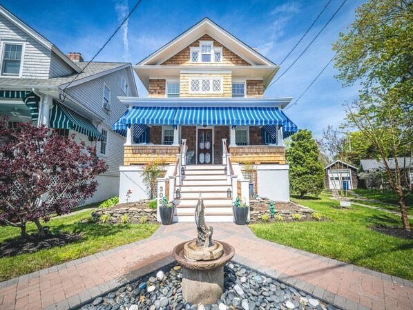Beautifully landscaped entrance with a garden fountain.