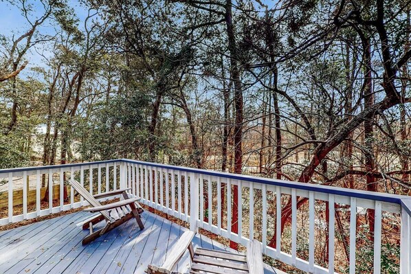 Spacious outdoor deck with beautiful wooded views—ideal for relaxing.