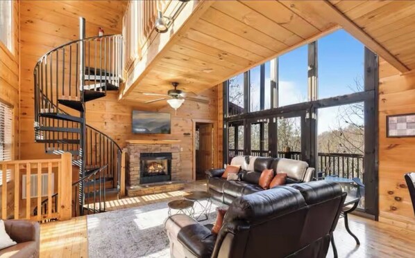 Large open living room, gas fireplace with entry to the back deck