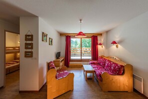A cosy and bright living area with traditional alpine decor, perfect for a relaxing mountain getaway