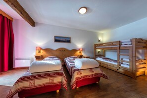 Twin beds with soft lighting and alpine-inspired decor make this room ideal for families or groups.