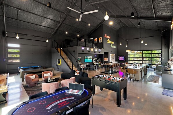 The Social Lounge is an entertainer's dream with multiple TVs, a 14-foot private bar, and a variety of gaming tables.