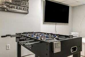 Basement with a game room including a pool table, foosball, smart TV and more!