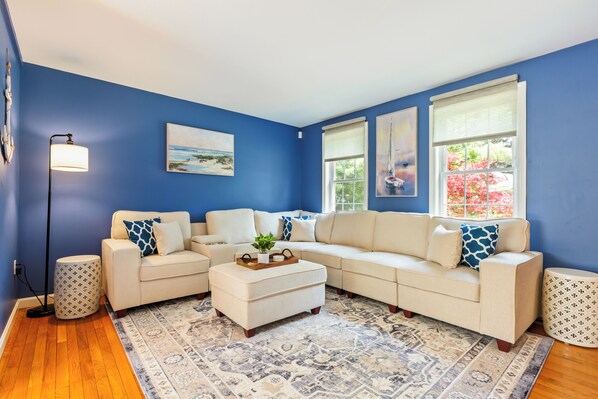 Cozy living room with sectional, smart TV and board games.

