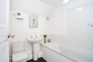 Over shower bath, toilet and sink
