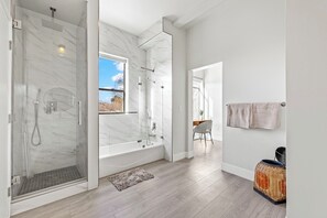 Indulge in luxury with cast iron tub and rain shower.