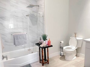 Indulge in luxury with cast iron tub and rain shower.