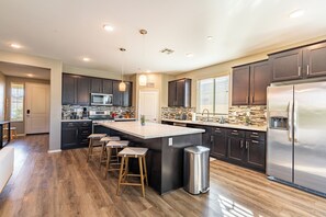 Fully equipped kitchen with barstool seating.