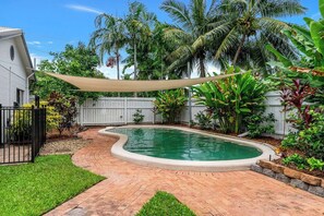 Dive into your private oasis, where a sparkling pool, sun loungers, and lush greenery create the perfect setting for cooling off and soaking up the tropical vibes.