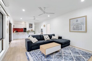 The open-plan design seamlessly connects the main living area to the kitchen and dining area for effortless socialising.