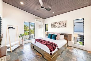 The spacious and airy master bedroom features a king-size bed and a ceiling fan, with air-conditioning throughout to keep everyone comfortable year-round. 
