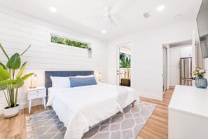 Relax in a serene costal suite with a king bed, patio access, and en-suite