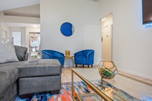 Spacious living room with a comfy couches and large TV.