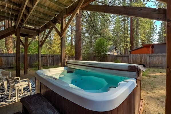 Gas BBQ, hot tub and seating in the backyard