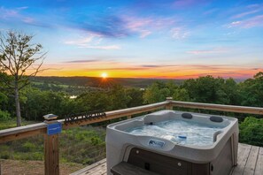 Soak in the hot tub while watching the sun dip behind the Ozark Mountains.